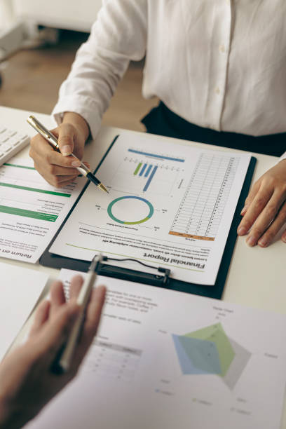 istock Business team meeting using calculator Working with laptop and charts and analyzing business strategy Financial statistics sitting at the table in the financial office in vertical view 1637591152