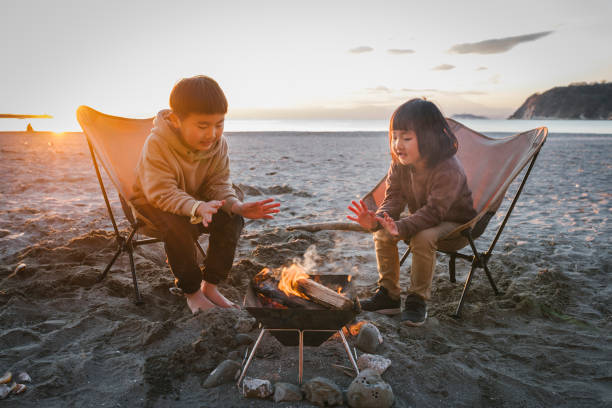 Asian brother and sister relaxed in the beach.