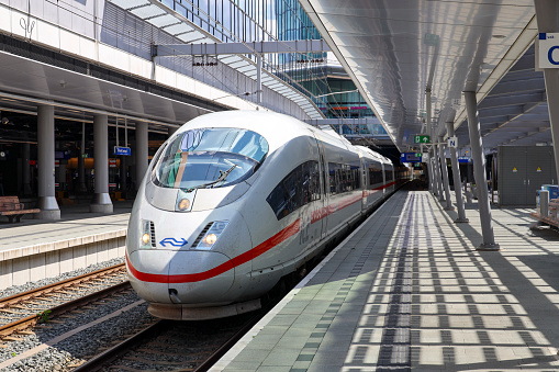 ICE high speed train heading from Germany to Amsterdam halting along platform in Utrecht central station