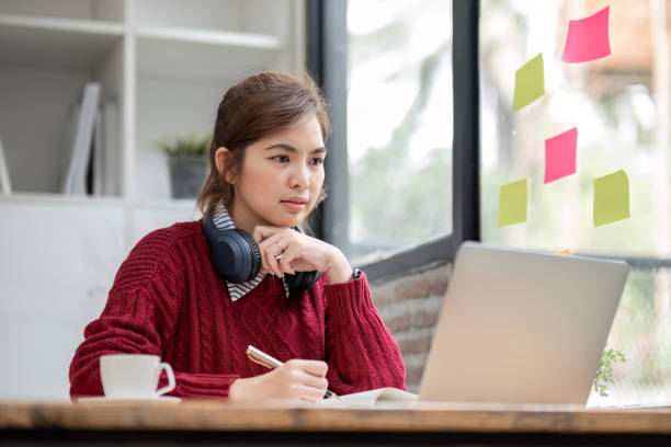 istock Asian female student study online in class, study online, wearing headphones, watching video call, zooming, happy asian female learning language online with computer laptop. 1637616244