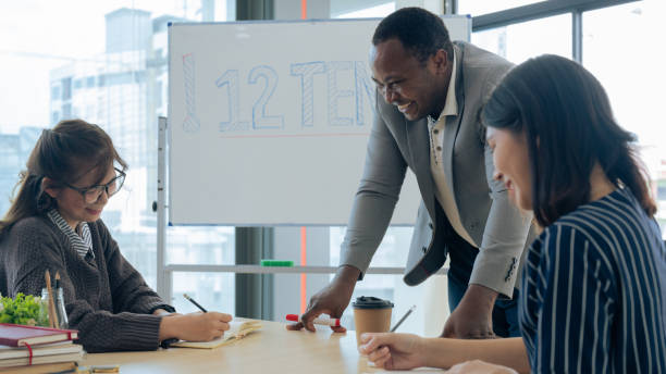 istock Mature professor talking to his student while assisting her on a class at the university 1637619445