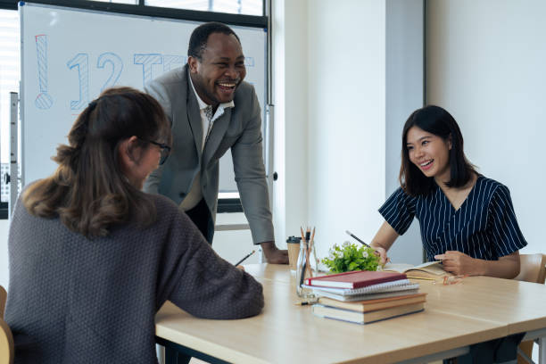istock Mature professor talking to his student while assisting her on a class at the university 1637619965