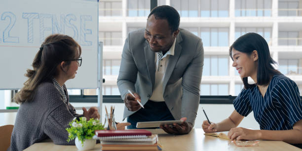 istock Mature professor talking to his student while assisting her on a class at the university 1637619992