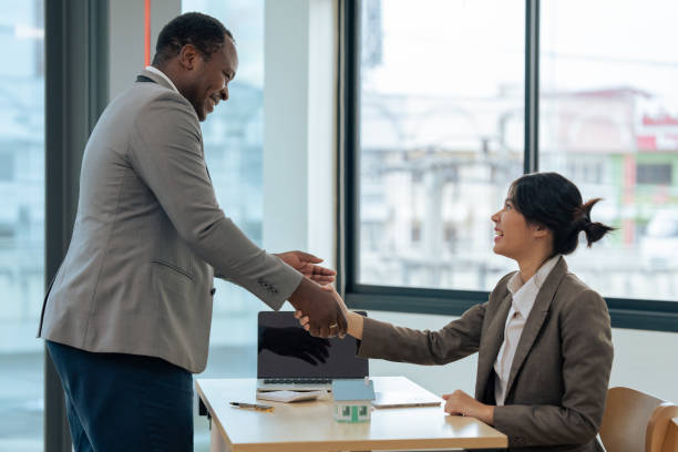 istock Real estate broker agent manager shaking hands with a client after successful agreement in the office 1637622724