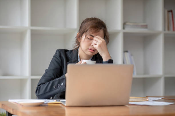istock Stressed and upset Asian female office worker looking at her laptop screen, pensive 1637625933