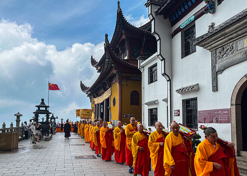 Chizhou, China - August 9, 2023: Buddhist monks conducting rite at Ancient Sutra Worship Platform on Tiantai Peak of Mount Jiuhua (Jiuhuashan), dedicated to Ksitigarbha Bodhisattva.