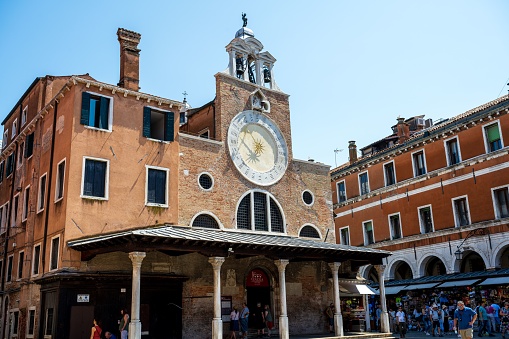 Venice, Italy – June 23, 2023: San Giacomo di Rialto church, with a 15th-century clock above the entrance, Venice, Italy.