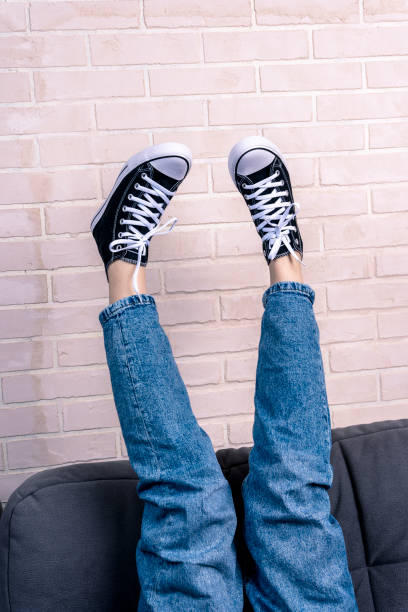 istock girl, is lying on the sofa with her legs thrown up 1637663665