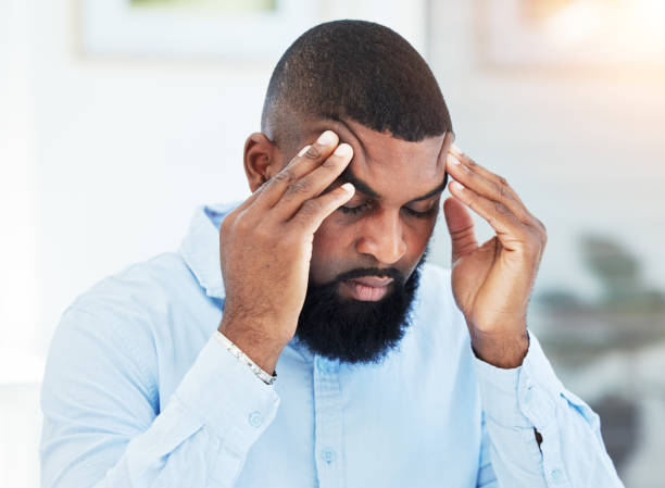 istock Stress, anxiety or tired businessman with headache overwhelmed by problems, mistake or failure. Stock market crash, burnout or frustrated black man trader overworked in office with fatigue or failure 1637669609