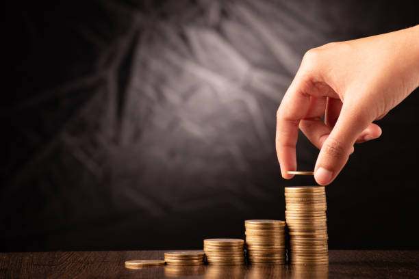 istock Hand putting coin stack money investment concept 1637672369