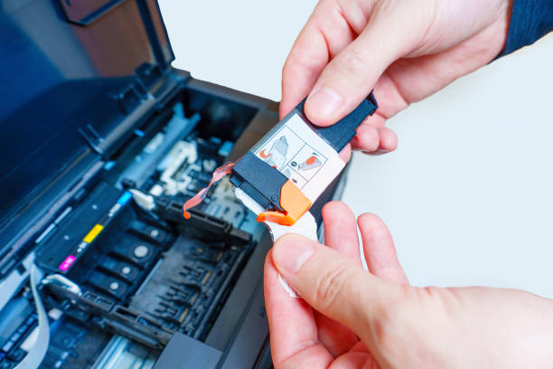 istock Removing Protective Tape from the Inkjet Printer Cartridge 1637676645