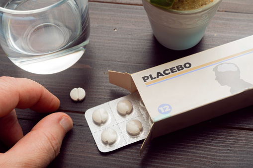 Placebo effect concept: man take a pill from a placebo box of pills