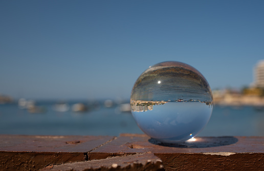 Woman hold a Crystal Ball with subway train reflection.