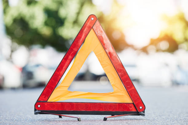 istock Red triangle, road sign and stop for emergency, construction or symbol for caution to driver on the ground, floor or street. Attention, warning and signal to traffic of an accident or problem 1637707482