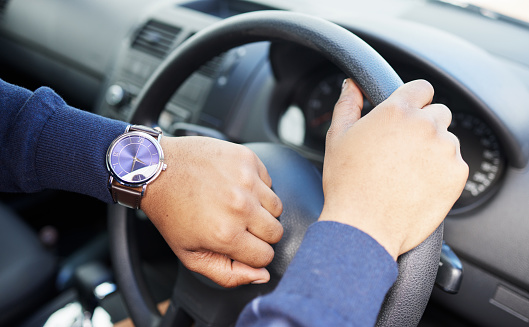 Hands, steering wheel and check watch for driver, travel schedule or traffic on street. Person, chauffeur or transport employee with clock, time or vehicle for journey, service or road trip adventure