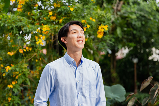 Young Japanese businessman in a suit looking at the camera