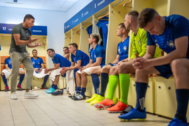 istock Coach explaining game strategy to football players 1637717285