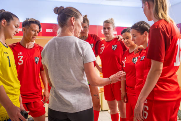 Coach instructing female football players