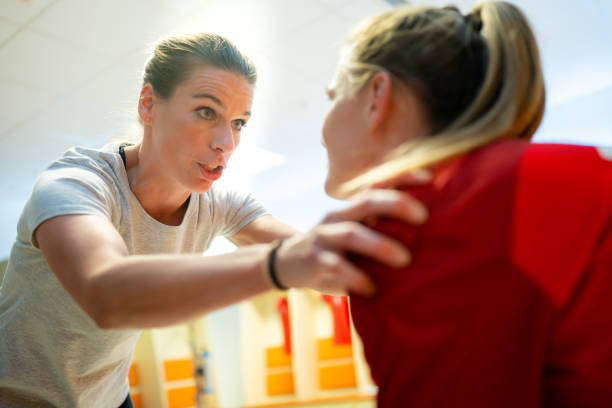 istock Female coach talking to football player 1637717295
