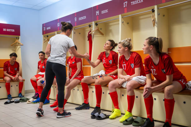 istock Coach instructing female football players 1637717304