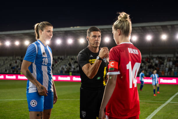 istock Referee with team captions on football pitch 1637717320
