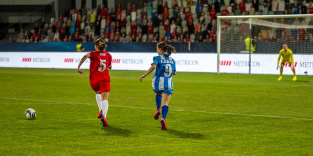 istock Football players running during match 1637717321