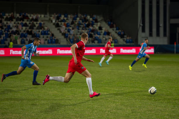 istock Football players running during match 1637717326