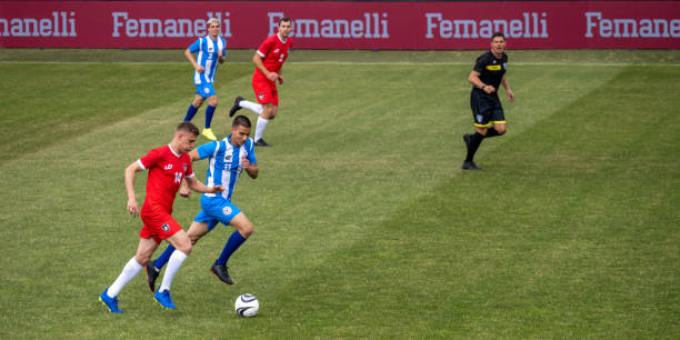 istock Football players playing during match 1637717333