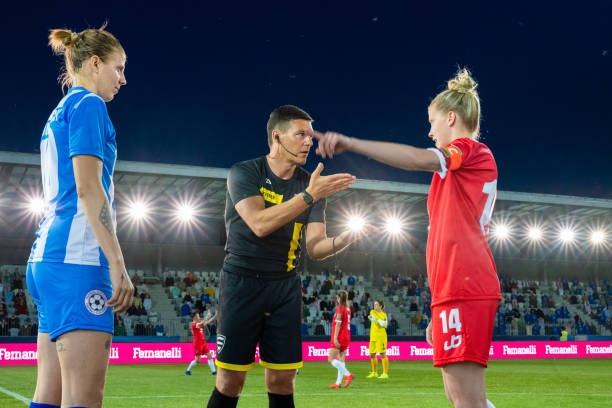 istock Referee with team captions on football pitch 1637717336