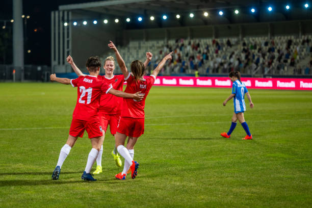 istock Football players celebrating on field 1637717340