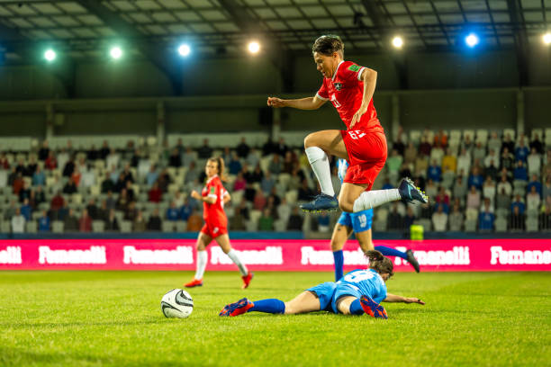 istock Football player jumping mid-air 1637717342