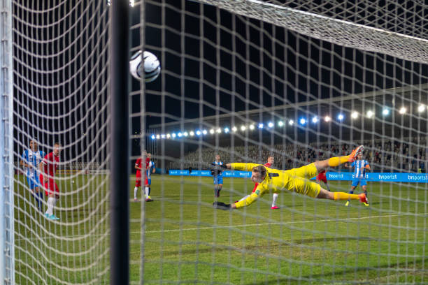 istock Football player diving mid-air 1637717350