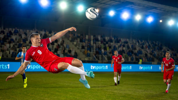 istock Football player jumping mid-air 1637717357