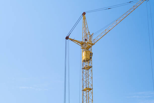 istock crane and a building under construction against a blue sky background 1637727582