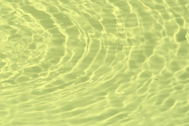 istock Blue water with ripples on the surface. Defocus blurred transparent blue colored clear calm water surface texture with splashes and bubbles. Water waves with shining pattern texture background. 1637764850