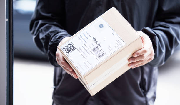 istock Box, hands and courier at with mail for a delivery, ecommerce work or cargo shipping. Closeup, logistics and man or person with package, stock or front door freight wholesale or distribution service 1637771994