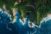 Scenic Landscape with coastline, rocks and blue ocean with waves in Indonesia. Aerial view.