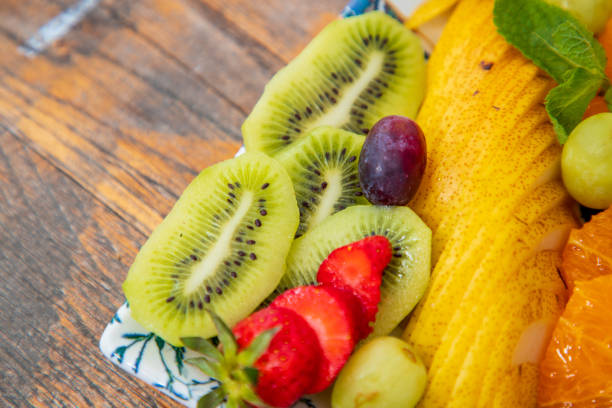 Close-up on tropical and continental fruit slices, offered on tray in fine dining
