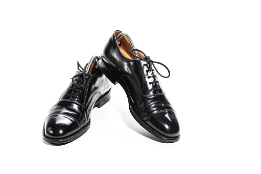 Formal Male Stylish Black Polished Oxford Leather Laced Shoes Placed Together Over White. Horizontal Composition