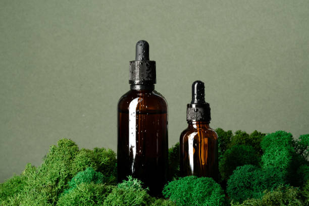 istock Vape smoking liquid bottles on moss background 1637795171