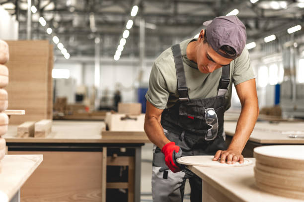 istock Young carpenter making wood furniture while working in joinery 1637802916