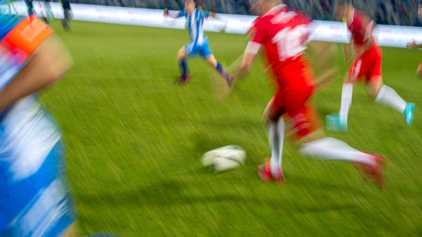 3d illustration young professional soccer player running dribbling and slide tackle in the stadium field with blue sky