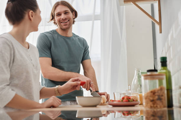 istock Happy couple making breakfast together in morning 1637841440