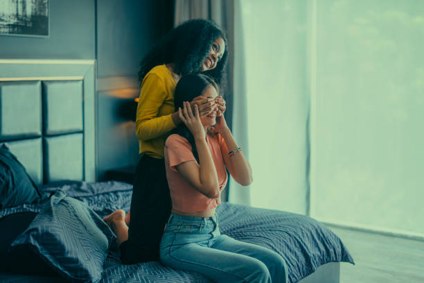 istock Lesbian couples playfully bond, sharing affectionate gazes, laughter, and intimate warmth on bed. 1637842002