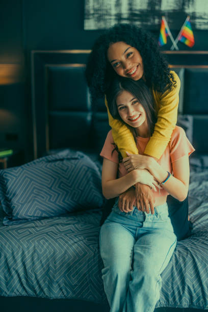 istock Lesbian couples playfully bond, sharing affectionate gazes, laughter, and intimate warmth on bed. 1637844216