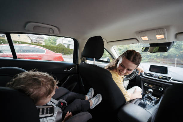 istock Mother checking her son before ride in car. 1637850042