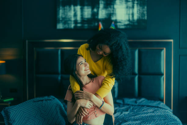 istock Lesbian couples playfully bond, sharing affectionate gazes, laughter, and intimate warmth on bed. 1637851692