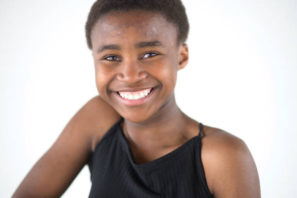 Shy and smiling young Black Girl Studio Headshot