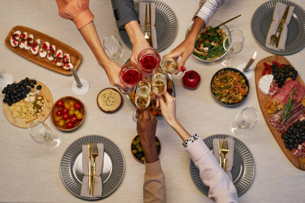 istock Above view of hands of several intercultural people clinking with drinks 1637862788