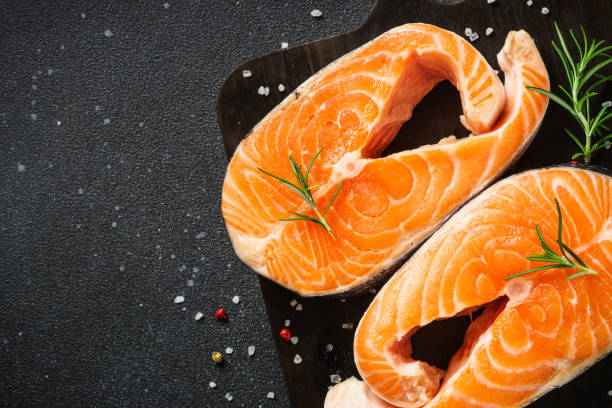 istock Salmon fish fresh salmon steak on black table. 1637899267